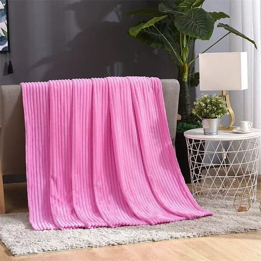 Hot Pink Bedding blanket laying over a couch in a living room