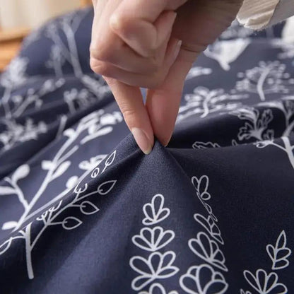Person Holding The Material of Blue and White Floral Bedding