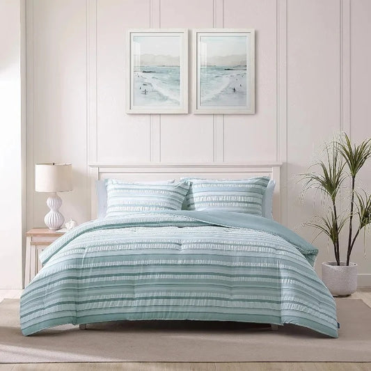 Bed standing in a boho decorated bedroom fitted with a Coastal Blue Bedding set