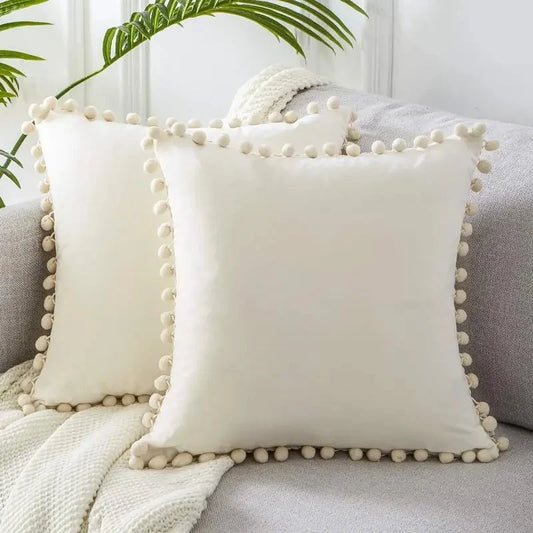 Two pillows sitting on a couch fitted with Farmhouse Pillow Covers 