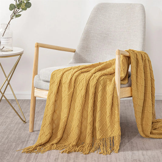 Brown Farmhouse Throw Blanket sitting on a chair next to a table