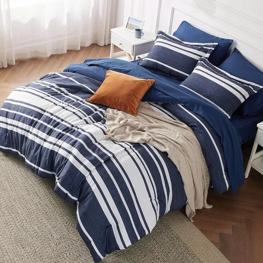 Bed standing in a white themed bedroom fitted with a Navy Blue Bedding set