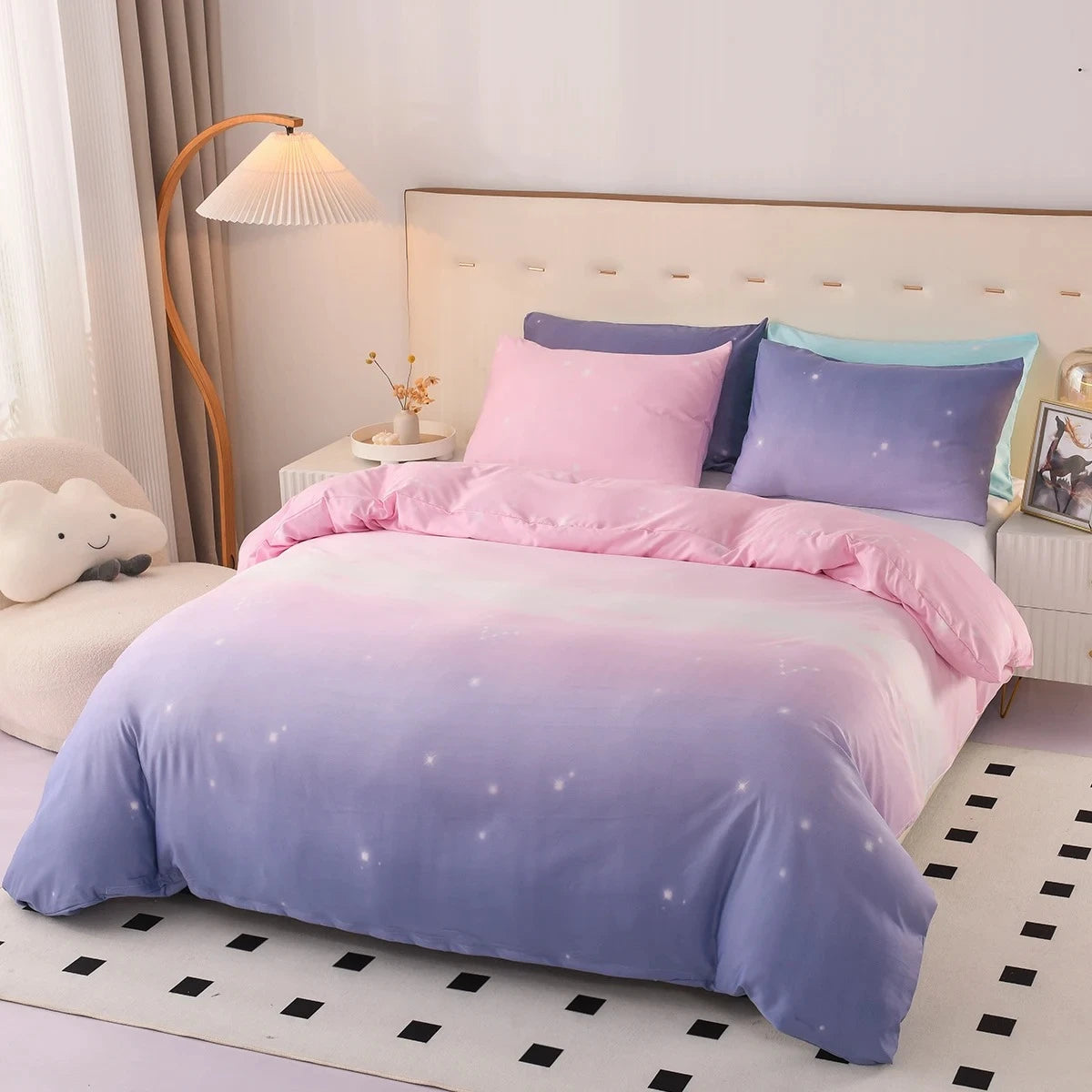 Bed standing in a bedroom fitted with a Pink and Purple Bedding set next to decorative elements