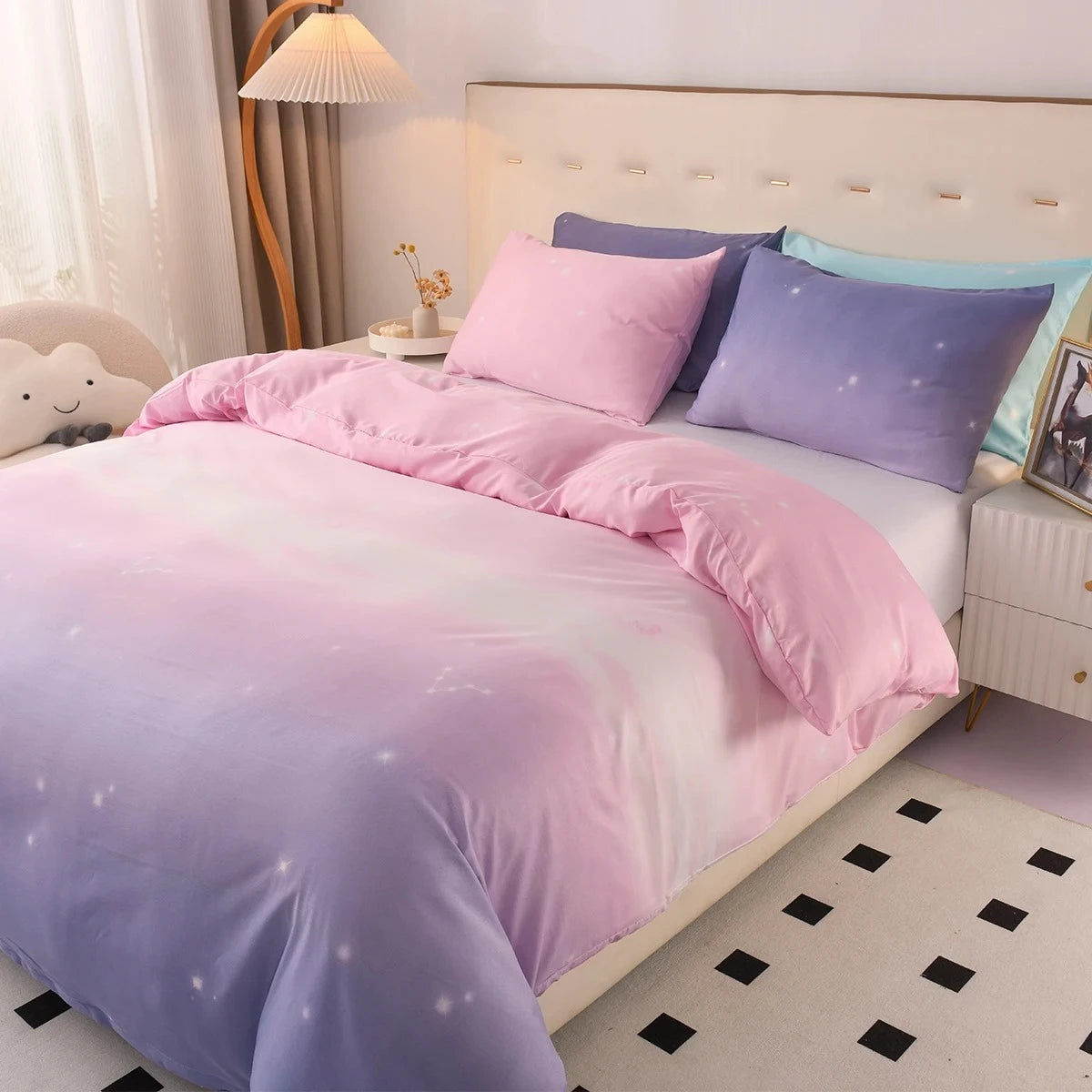 Bed featuring a Pink and Purple Bedding set on it