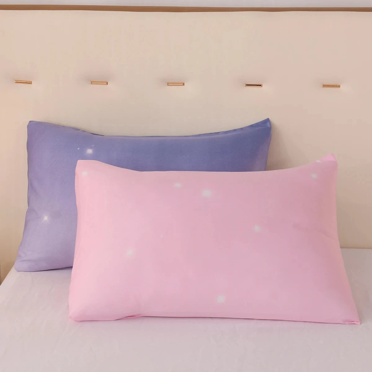 Two pillows fitted with pink and purple pillow covers
